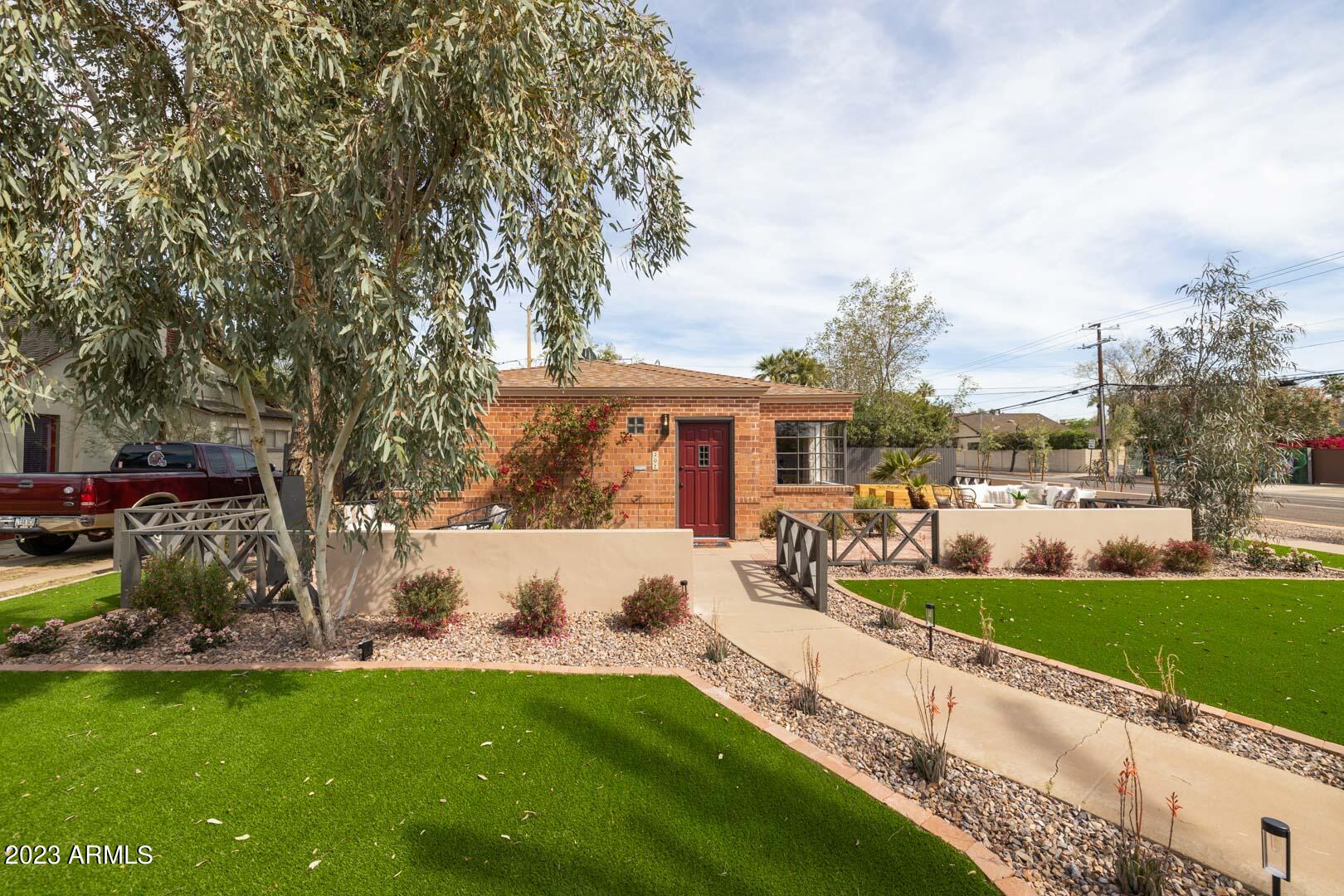 302 West Granada Road Phoenix, AZ 85003 - Photo 4 of 81 a view of a house with a big yard and large trees