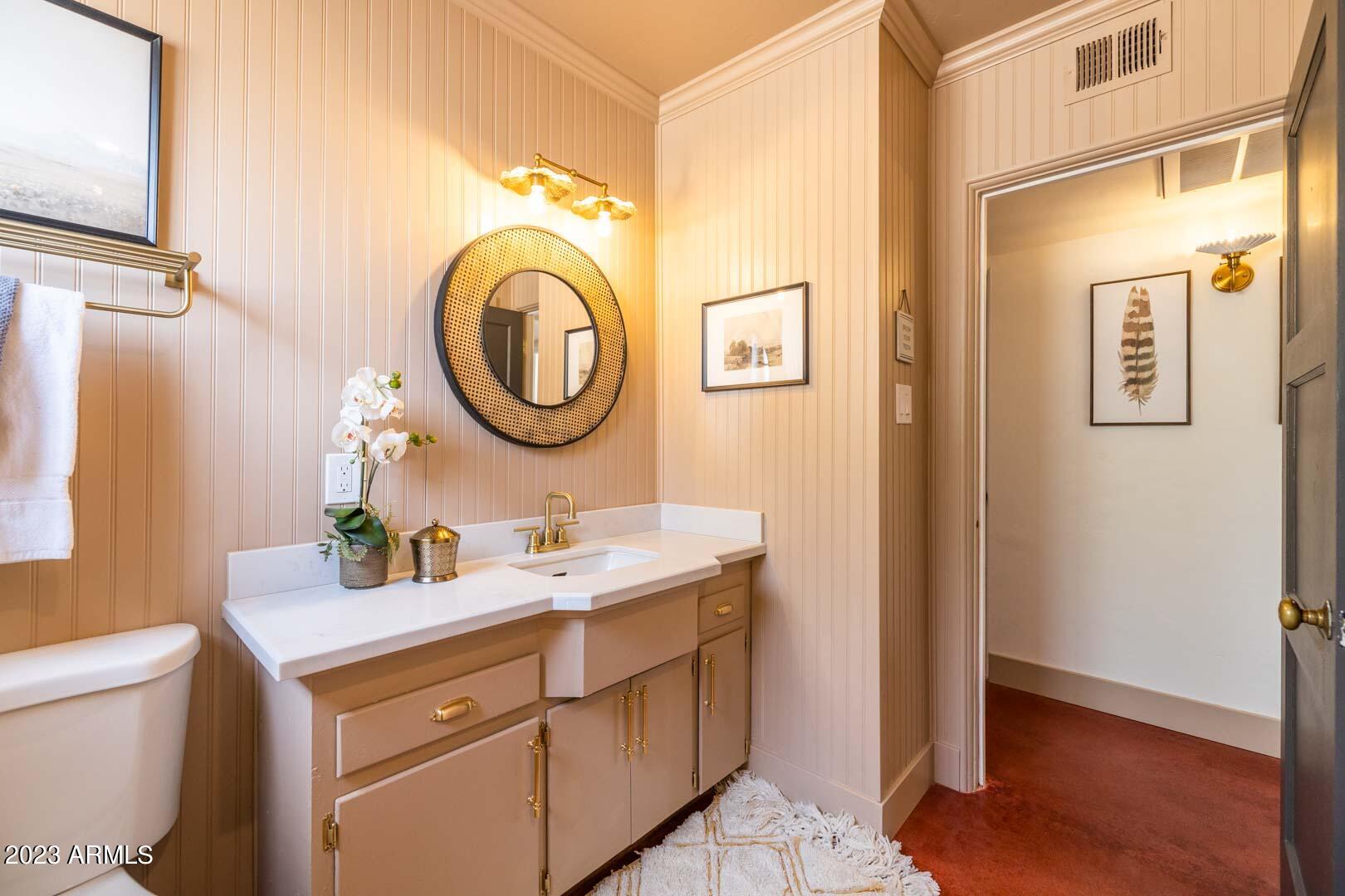 302 West Granada Road Phoenix, AZ 85003 - Photo 47 of 81 a bathroom with a toilet a sink and a mirror