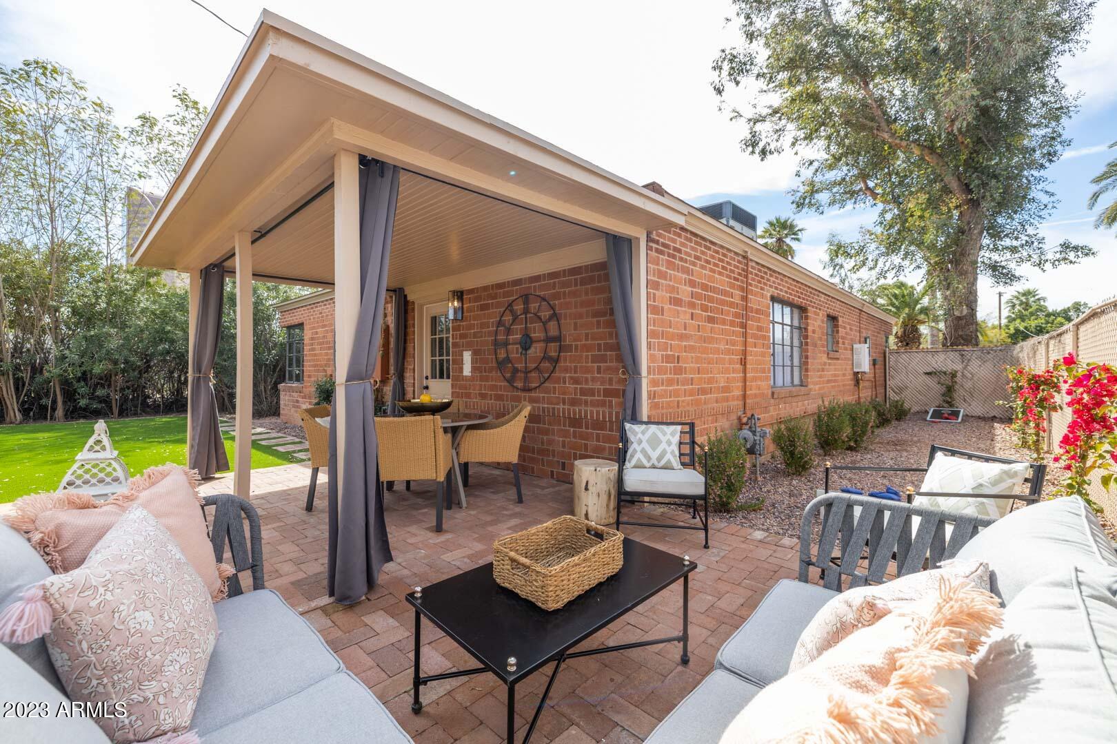 302 West Granada Road Phoenix, AZ 85003 - Photo 62 of 81 a view of a patio with a dining table and chairs with wooden floor and fence
