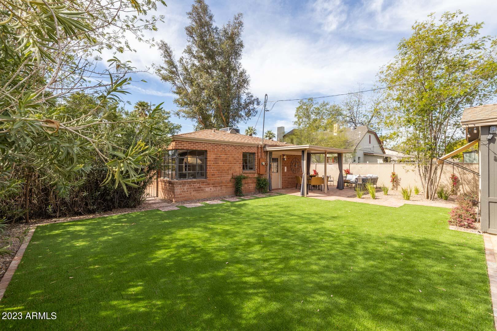 302 West Granada Road Phoenix, AZ 85003 - Photo 75 of 81 a front view of a house with a garden and trees