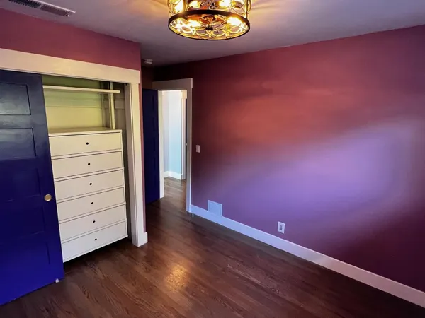 a bathroom with a toilet mirror and vanity