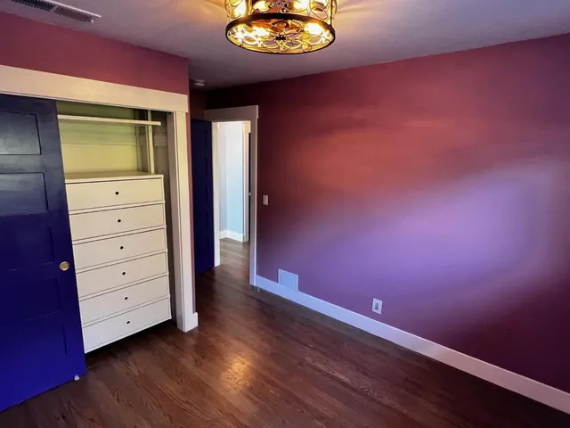 a bathroom with a toilet mirror and vanity
