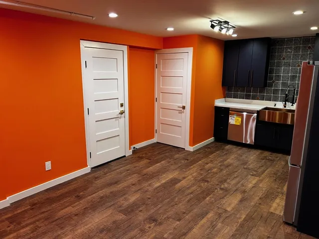 an empty room with wooden floor and closet