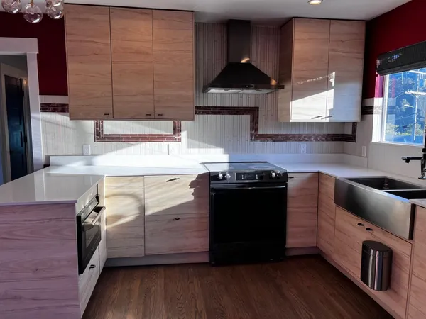 a kitchen with stainless steel appliances wooden floor and refrigerator