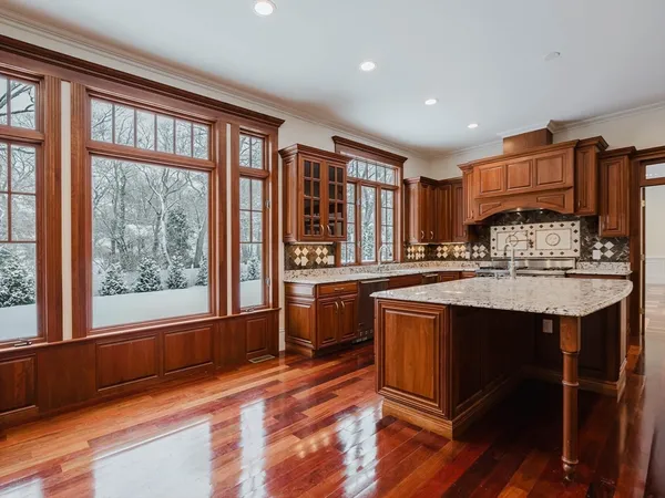 a kitchen with stainless steel appliances granite countertop a stove a sink and a refrigerator