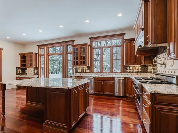 a kitchen with stainless steel appliances granite countertop a stove and a sink