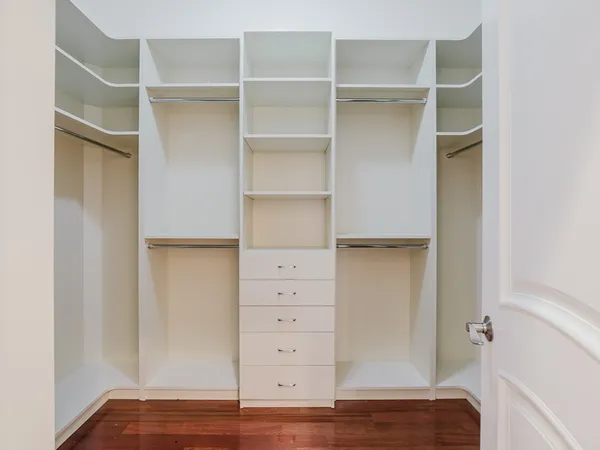 a view of walk in closet with empty racks