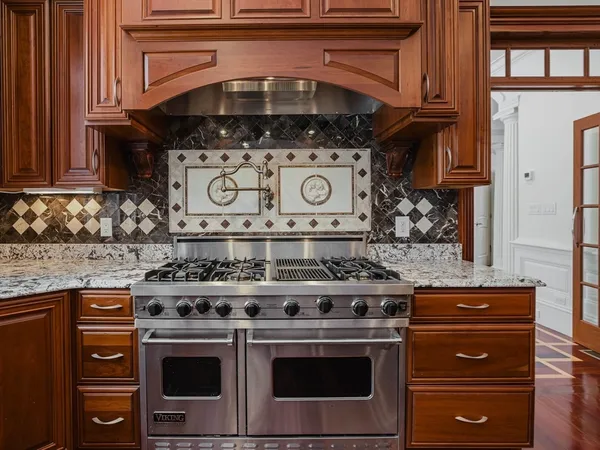 a stove top oven sitting inside of a kitchen