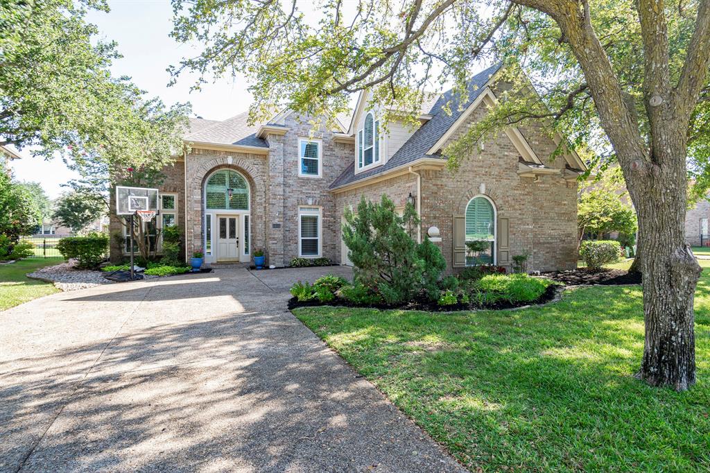 322 Spyglass Drive Coppell, TX 75019 - Photo 1 of 1 a front view of a house with a garden and trees
