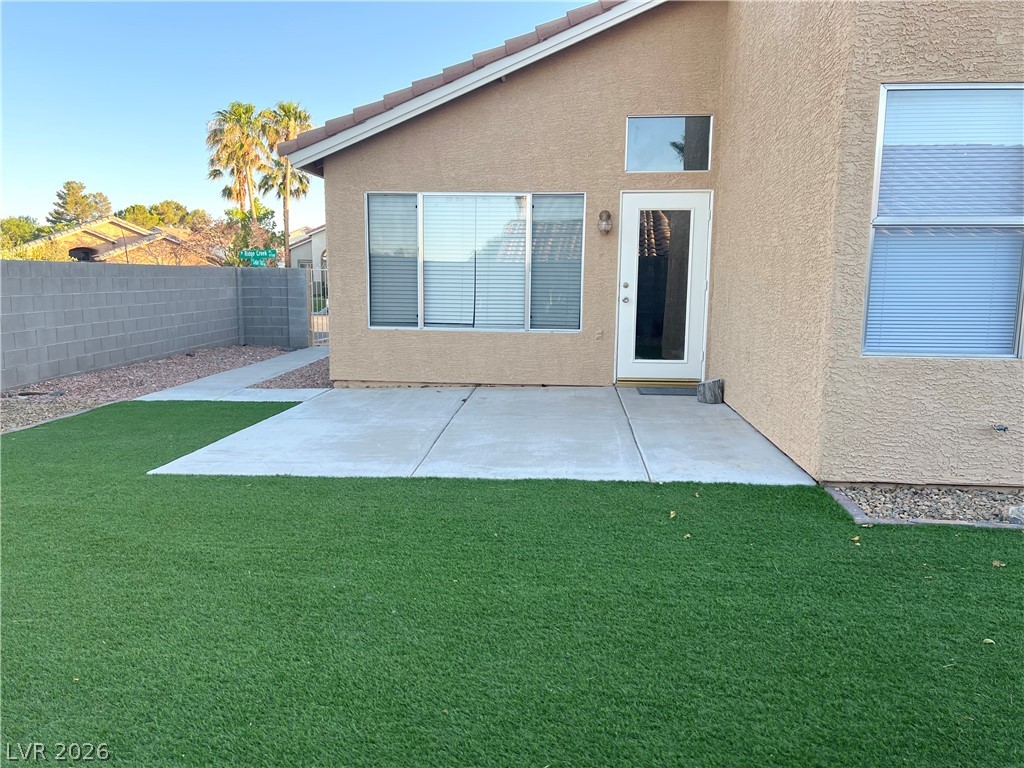 9708 Ridge Creek Place Las Vegas, NV 89134 - Photo 36 of 43 A private yard with durable synthetic turf and a concrete patio awaits outdoor enjoyment.