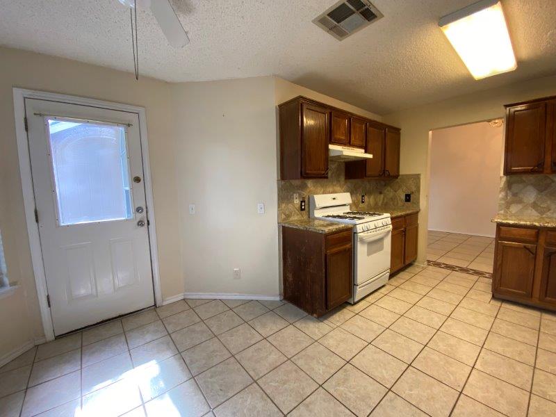 1903 Balsam Way Round Rock, TX 78665 - Photo 6 of 21 Functional kitchen with ample cabinetry and easy-to-maintain tile flooring.