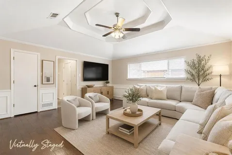 a living room with furniture ceiling fan and a window