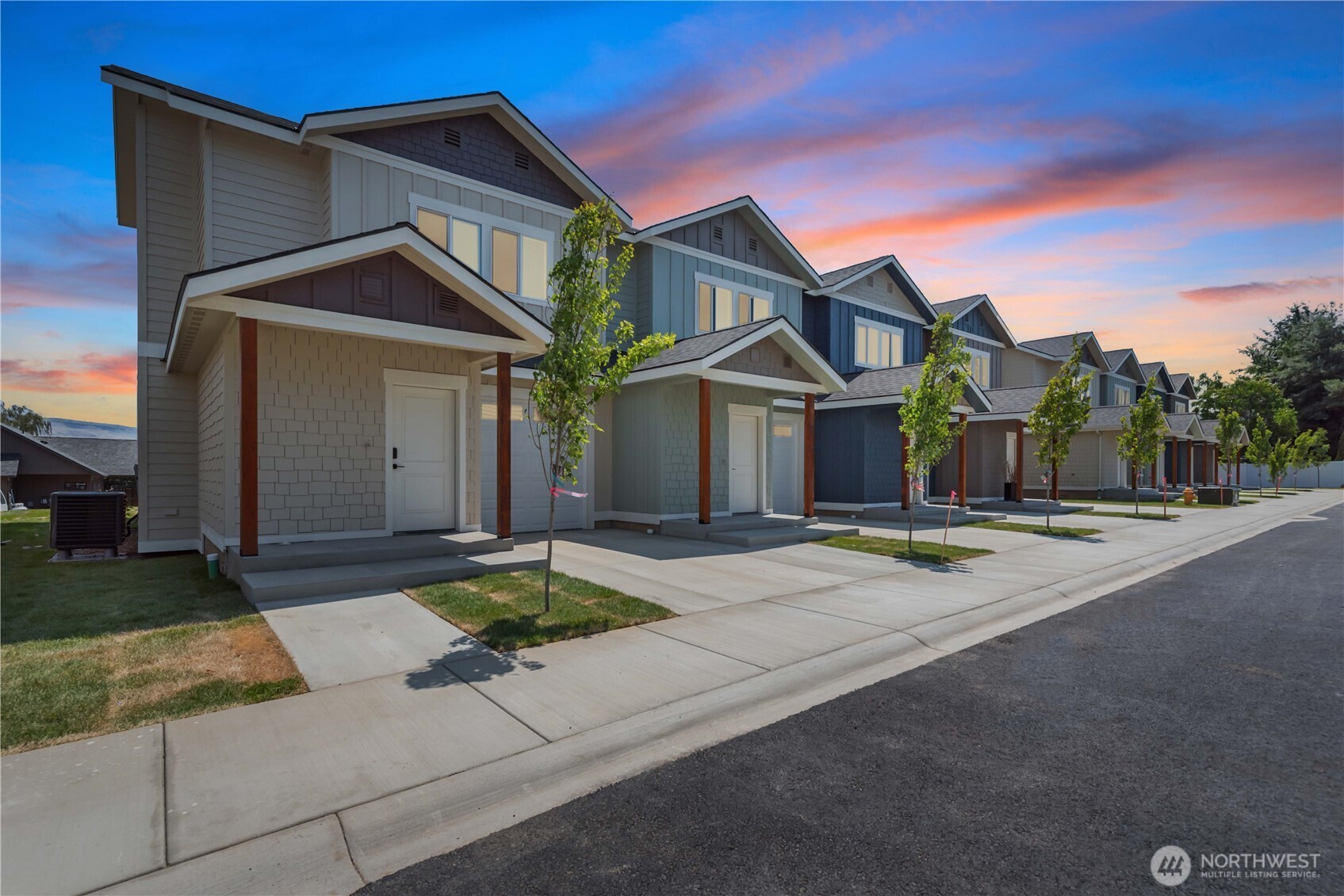 a front view of a house with yard and garage