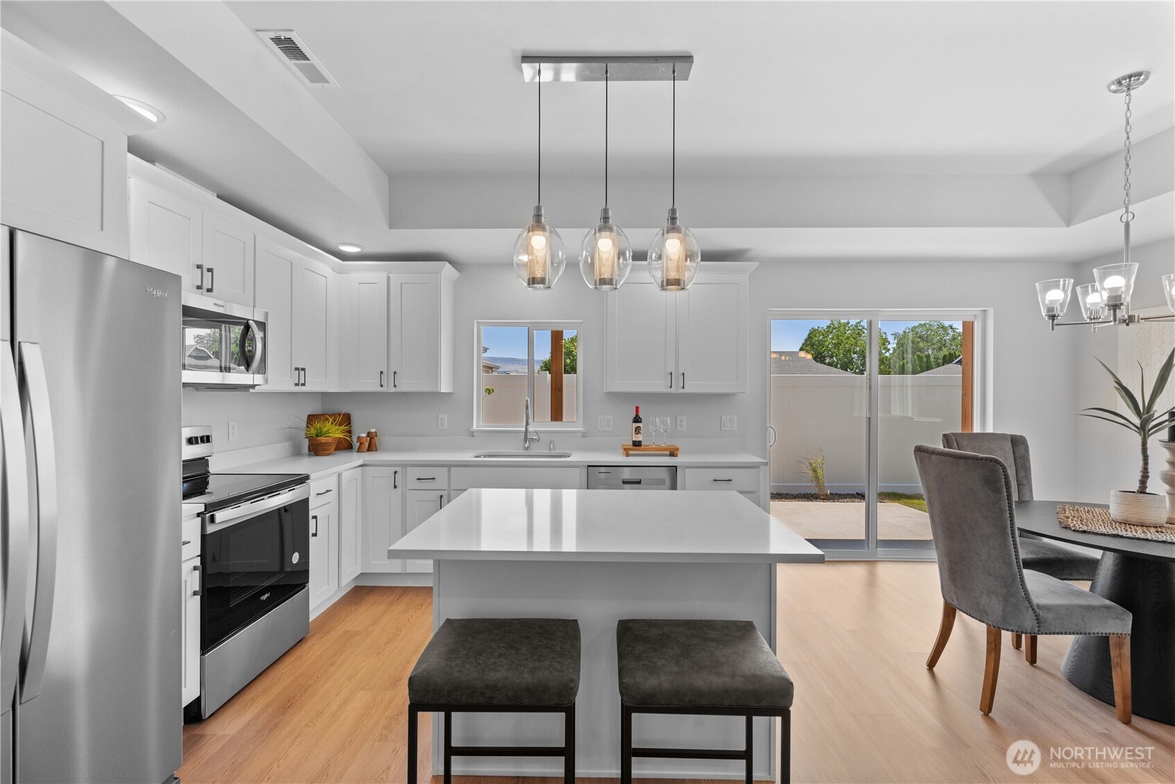 1030 Finch Lane, Unit A1 Wenatchee, WA 98801 - Photo 8 of 28 a kitchen with cabinets a sink stainless steel appliances and dining table