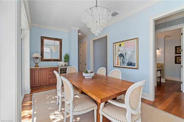 a view of a dining room with furniture wooden floor and a chandelier