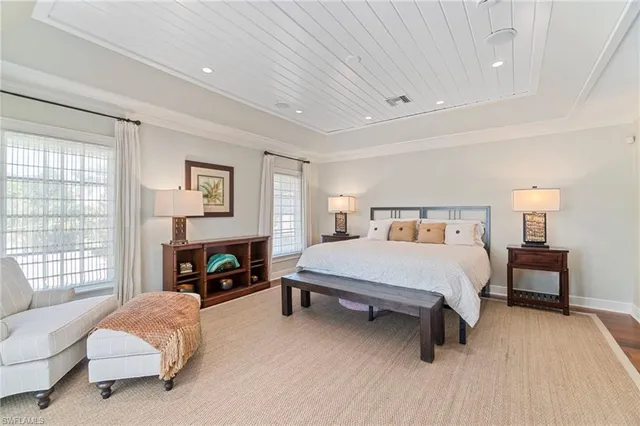 a spacious bedroom with a bed and a couch