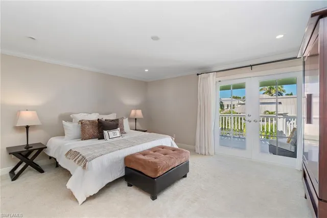 a bedroom with a large bed and a lamp next to a window