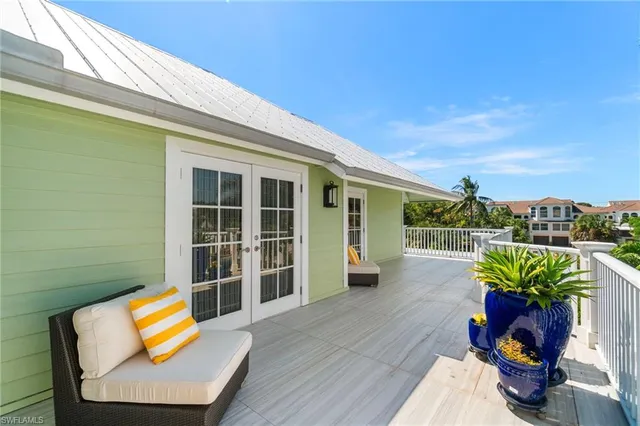 a balcony with furniture and a potted plant