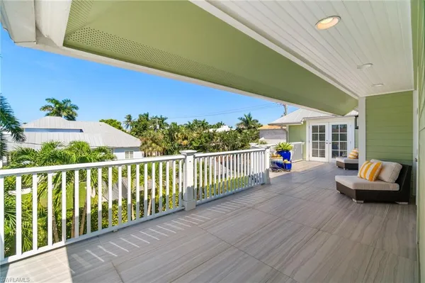 a balcony with furniture and a potted plant
