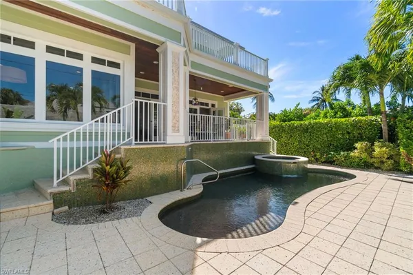 a view of a swimming pool with lounge chair