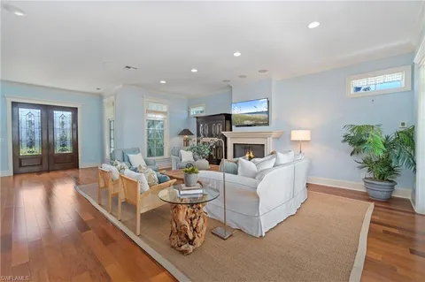 a living room with fireplace furniture and a wooden floor