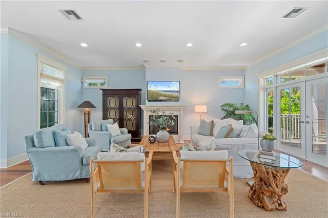 a living room with fireplace furniture and a large window