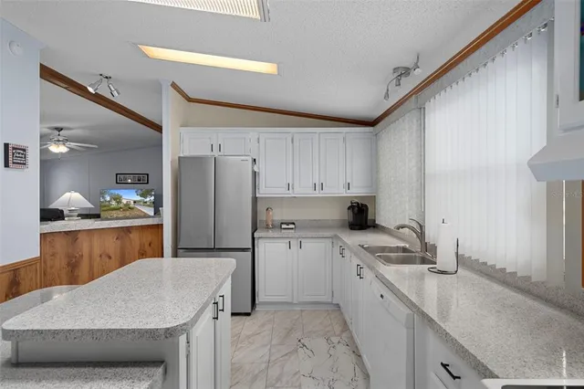 a kitchen with a sink stove and refrigerator