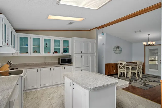 a kitchen with a table and chairs in it