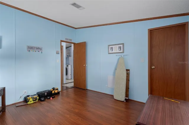 a view of room with wooden floor and stairs