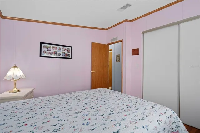 a bedroom with a bed and a lamp