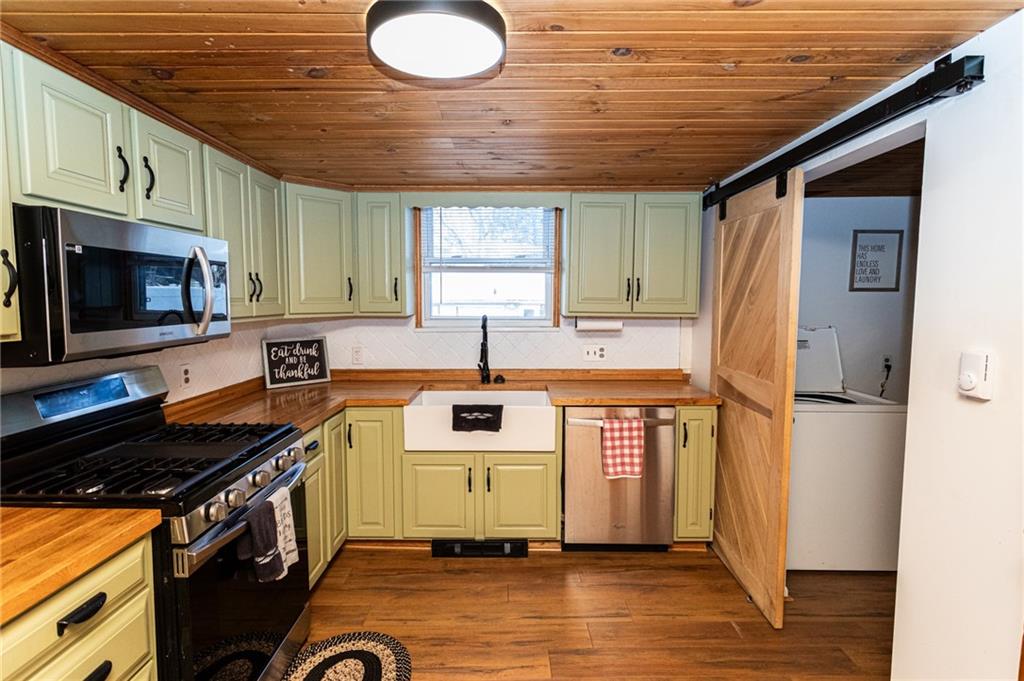 1001 Springfield Pike Connellsville, PA 15425 - Photo 13 of 35 a kitchen with a refrigerator a stove top oven a sink and dishwasher