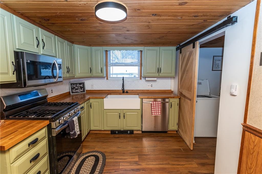 1001 Springfield Pike Connellsville, PA 15425 - Photo 14 of 35 a kitchen with a stove a refrigerator and a sink