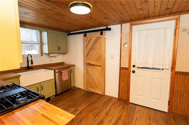 a view of a kitchen with wooden floor and a sink