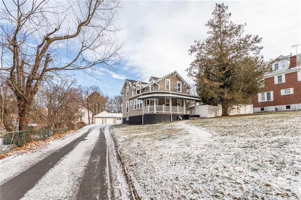1001 Springfield Pike Connellsville, PA 15425 - Photo 2 of 35 a front view of a house with a yard covered with snow