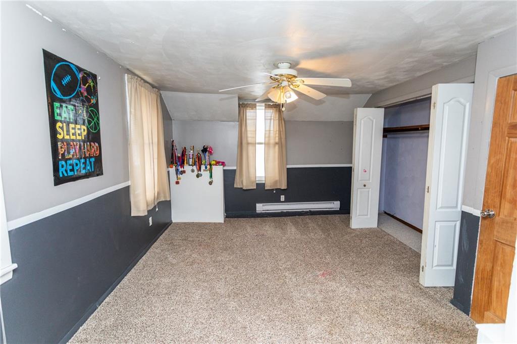 1001 Springfield Pike Connellsville, PA 15425 - Photo 29 of 35 an empty room with windows and ceiling fan