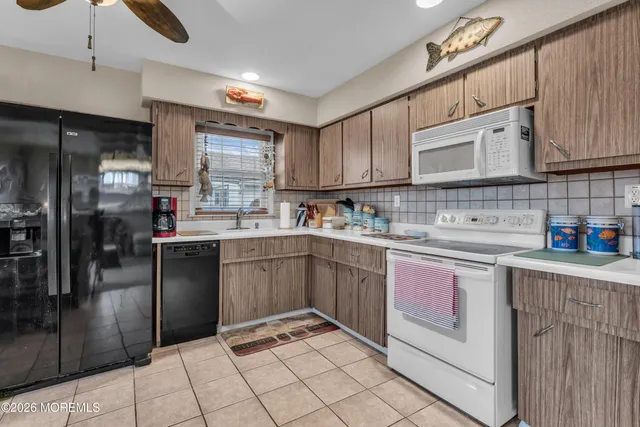 an aerial view of residential houses with outdoor space and lake view