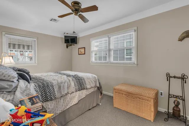 an aerial view of ocean and residential houses with outdoor space