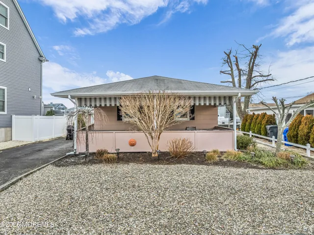 an aerial view of residential houses with outdoor space and lake view