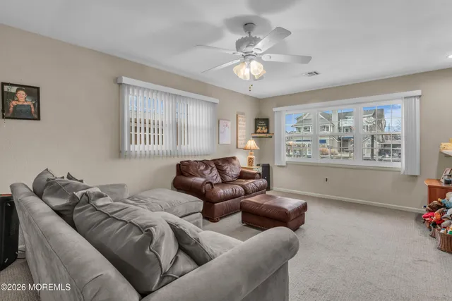 a bedroom with a bed a couch and a window