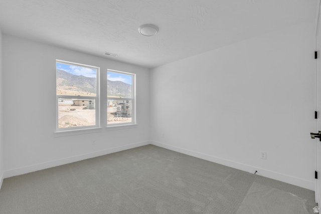 2821 Scarlet Road, Unit 149 Eagle Mountain, UT 84005 - Photo 17 of 28 Bright bedroom and a large window offering expansive outdoor scenery.