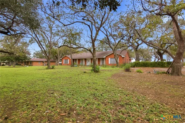 a view of house with yard