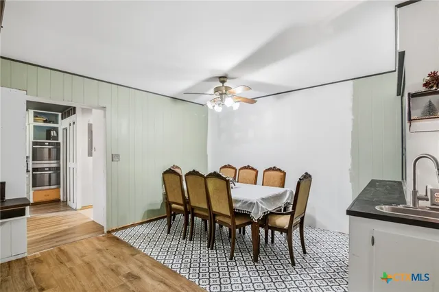 a view of a dining room with furniture and chandelier
