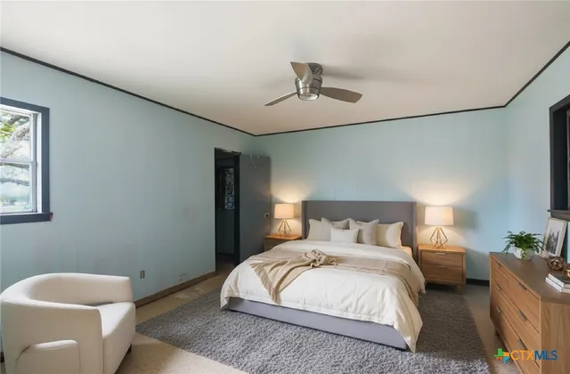 a bedroom with a bed and a potted plant