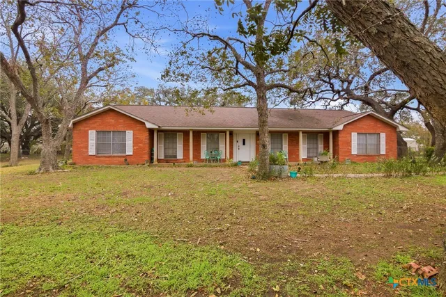 a front view of house with yard and green space