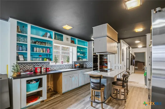 a kitchen with a sink and cabinets