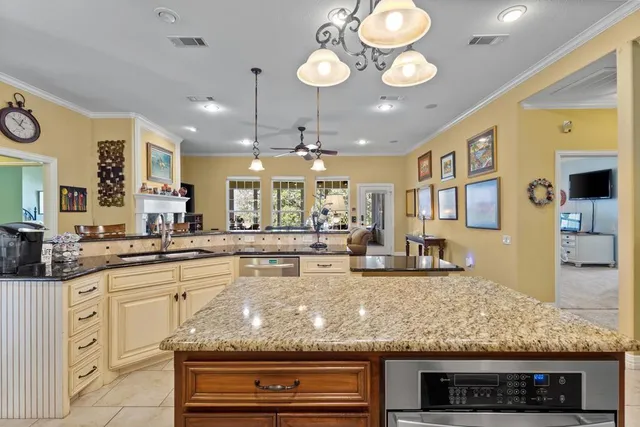 a kitchen with stainless steel appliances granite countertop a stove and cabinets