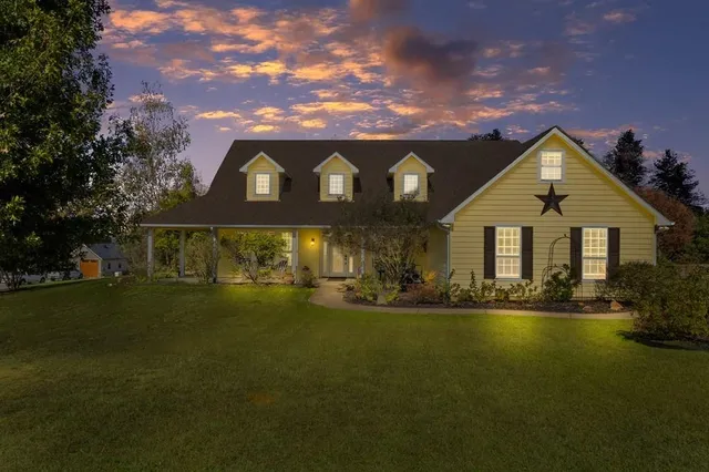 a front view of a house with a yard