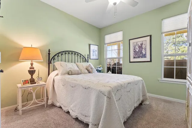 a spacious bedroom with a bed and a cabinets