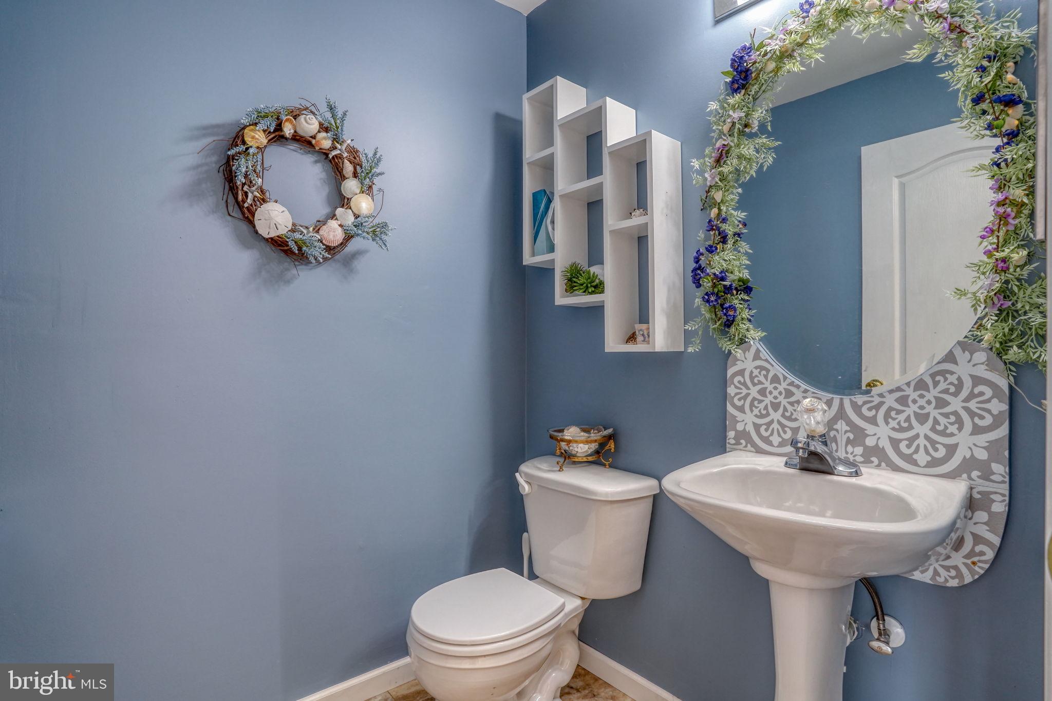 197 Bonnybrook Road Middletown, DE 19709 - Photo 15 of 32 a bathroom with a toilet sink and mirror