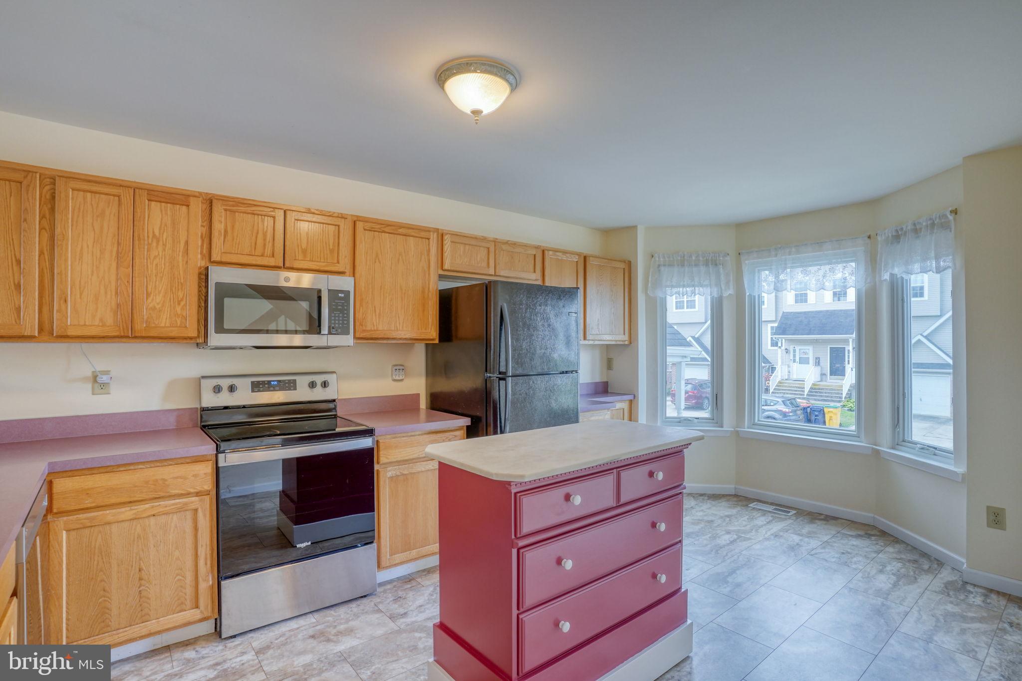 197 Bonnybrook Road Middletown, DE 19709 - Photo 3 of 32 a kitchen with granite countertop wooden cabinets stainless steel appliances and a window